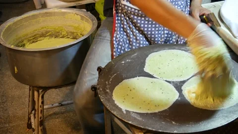 Making thin roti sheets for Thai snack o... | Stock Video | Pond5