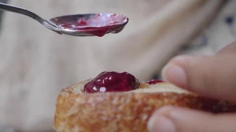 Making toast with jam in the kitchen at home Stock Footage 343658865