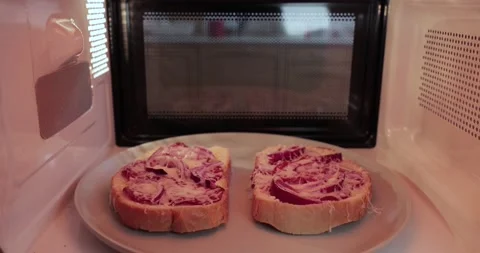 Making toast in a microwave oven, inside vew Stock Footage 146085968