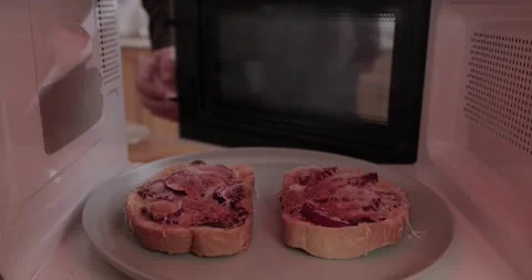 Making toast in a microwave oven, inside vew Stock Footage 146826186