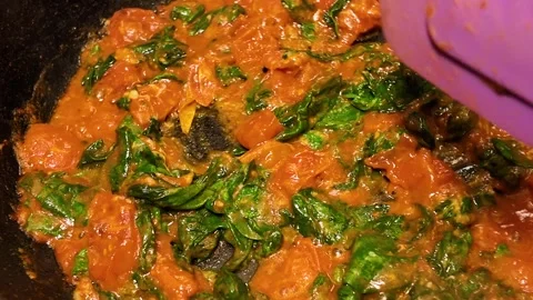 Making a tomato and spinach sauce for pasta in a frying pan Stock Footage 341616715