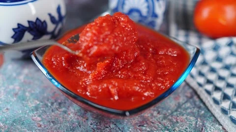 Making tomato sauce in a simple kitchen setting Stock Footage 336650757