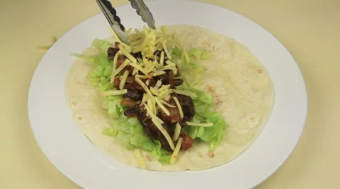 Making A Tortilla Wrap With Avocado Salsa Stock Footage 46950026