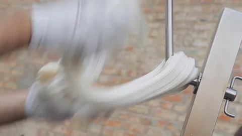 Making traditional caramel candy. Closeup of stretching caramel on hook. Video stock 74806603