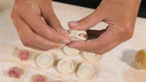 Making traditional Russian dumplings. Chef hands forming small handmade ravioli Stock-Footage 201020282