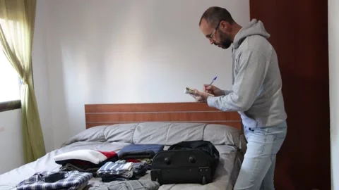 Making travel suitcase list Stock Footage 237372701
