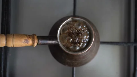 Making turkish coffee in copper cezve over gas stove.Boil coffee from the Turks. Video stock 86212193