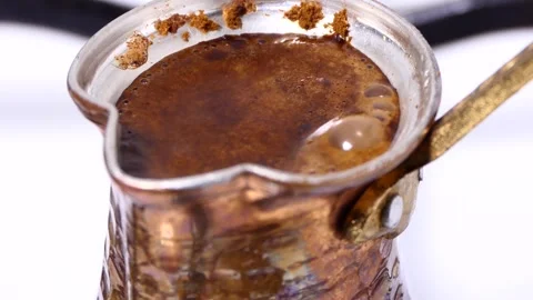 Making turkish coffee in copper cezve over gas stove Stock Footage 247784982