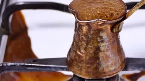 Making turkish coffee in copper cezve over gas stove Stock Footage 247789994