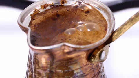 Making turkish coffee in copper cezve over gas stove Stock Footage 247790079