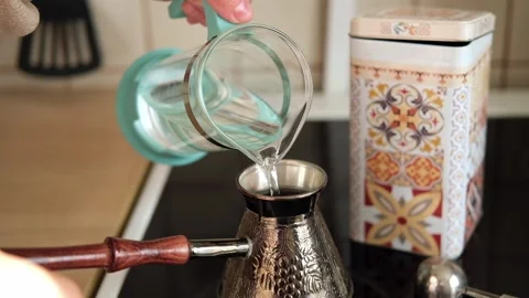 Making Turkish coffee in copper turk or cezve. Brewing coffee in the morning at Stock Footage 292980591