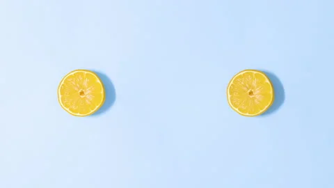 Making two creative yellow flowers made of lemon and flower petals. Stop motion Video stock 152911392