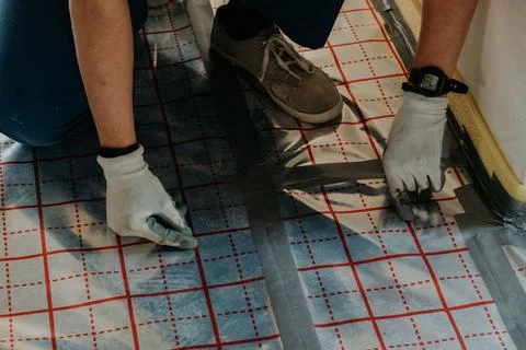 Making underfloor heating - preparing thermal foil Stock Photos
