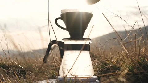 Making v60 coffee on portable camping gas burner with Carpathian mountains Stock Footage 255864865