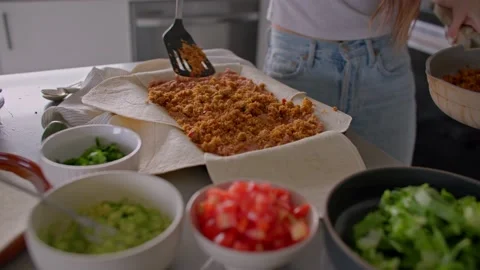Making vegan crunch wrap supremes in kitchen Stock Footage 220755060