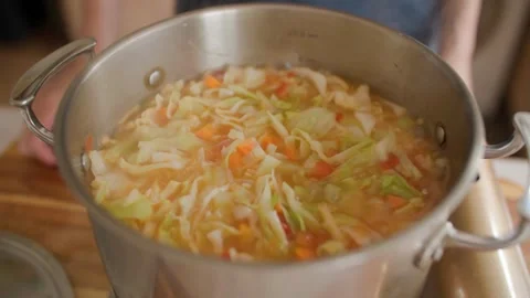Making Vegetable Soup in a Cozy Home Kitchen – Ingredients and Cooking Process Stock Footage 296836181