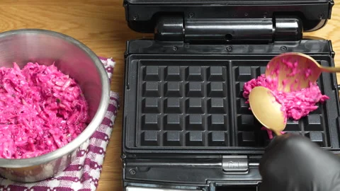 Making vegetarian beetroot and zucchini waffles with herbs in waffle maker Stock Footage 319744323