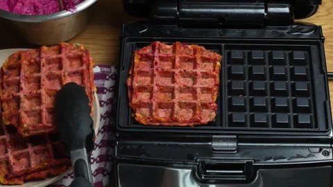 Making vegetarian beetroot and zucchini waffles with herbs in waffle maker Stock Footage 319744484