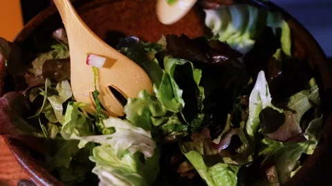 Making Vegetarian Salad In the kitchen. unrecognizable woman mixing lettuce.. Video stock 277456935
