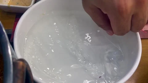 Making Vietnamese spring rolls by soaking rice paper in water. softened rice Stock-Footage 301517976