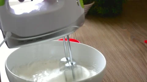 Making whipped cram by electric beater. Making foam into the bowl by beater 動画素材 150646125