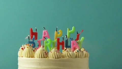 Making a wish and blowing out candles on a cake Stock Footage 229324742