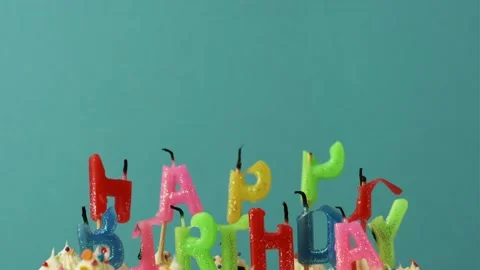Making a wish and blowing out candles on a cake Stock Footage 229783613