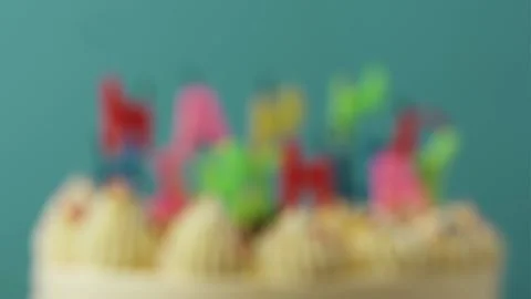 Making a wish and blowing out candles on a cake Stock Footage 229783616