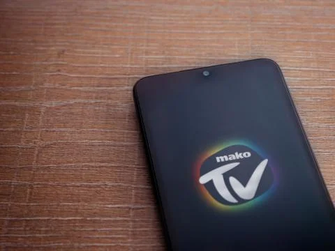 Mako TV app launch screen with logo on the display of a black mobile smartpho Stock Photos