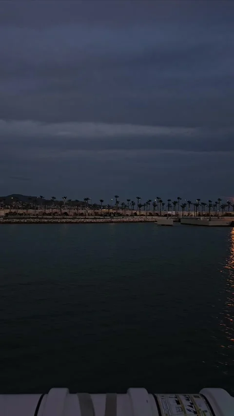 Malaga Spain April 6th 2025 Calm sail at twilight with a view of the distant Stock Footage 306667047