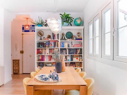 Malaga, Spain. Circa January 2020. Cozy stylish bright living room with shelf Stock Photos