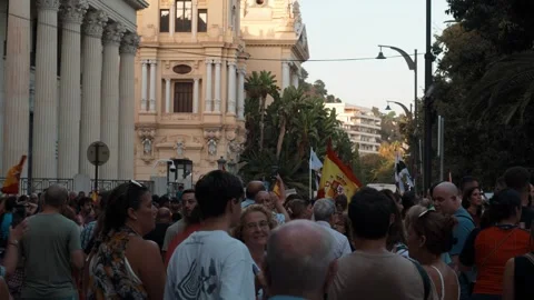 MALAGA, SPAIN - SEPTEMBER 2, 2026: People gather on a Malaga city street ou.. Stock Footage 344584131