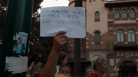 MALAGA, SPAIN - SEPTEMBER 2, 2026: A protester in Malaga holds a sign that .. Stock Footage 344584179