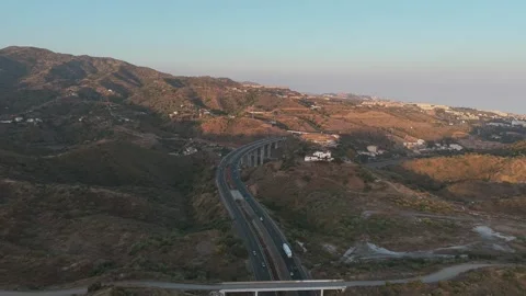 Malaga Spain, Sunset aerial reverse view over Viaducto del Rio Totalan Motorway Stock Footage 339245527
