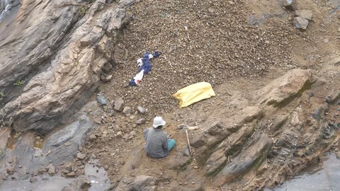 Malagasy Man Breaks Rocks To Make Gravel For Construction Stock Footage 125347735