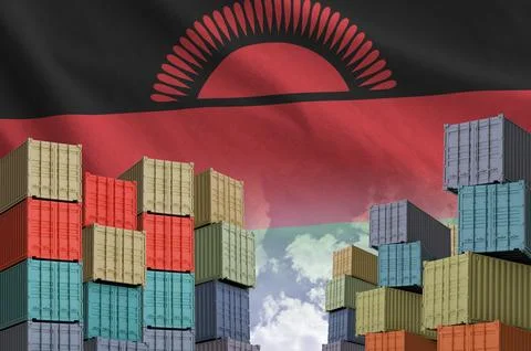 Malawi flag and big stack of shipping cargo containers in docks with sky Stock Photos