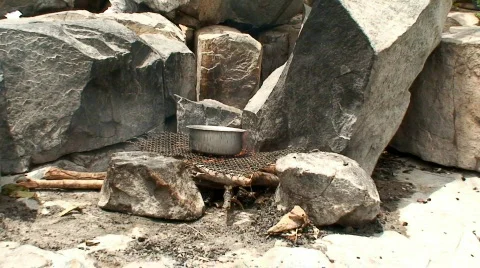 Malawi: preparing fireplace on a rock 2 Stock Footage 362990