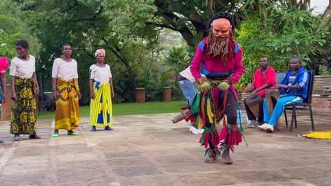 Malawian man in a mask performs a traditional dance. Stock Footage 334412008