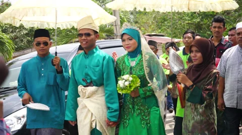 Malay Bride and Groom Walking Alongside Stock Footage 34974904