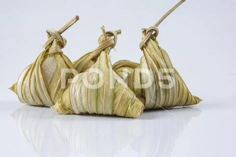 Malay dish ketupat daun palas or rice dumpling where glutinous rice is wrappe Stock Photos