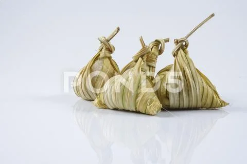 Malay dish ketupat daun palas or rice dumpling where glutinous rice is wrappe Stock Photos