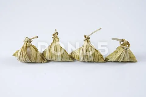 Malay dish ketupat daun palas or rice dumpling where glutinous rice is wrappe Stock Photos