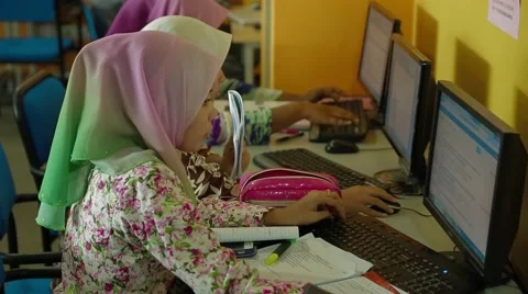 Malay Female Students Doing School Assignment on Desktops in Library Stock Footage 49388052