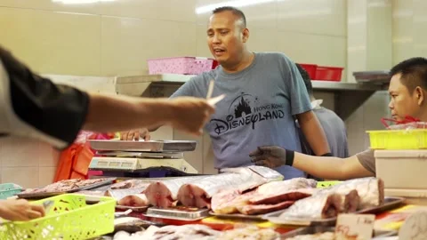 Malay man selling fish and seafood at the market Stock Footage 229779090