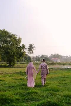 Malay Wedding Couple Bride and Groom holding hands Stock Photos