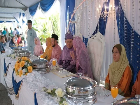 Malay wedding coupled enjoying Cak Lempong Stock Footage 80151055