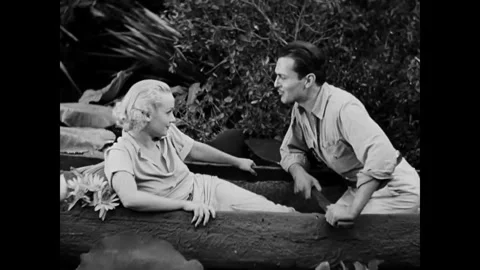 MALAYSIA - 1933 - in this romance, floating down the jungle river in a canoe, a Stock Footage 340998613