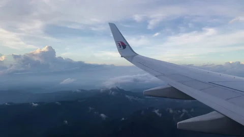 Malaysia airlines flight. A view of the wing and the mountains below. Stock Footage 239431946