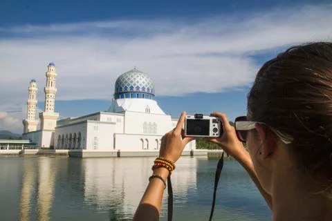 Malaysia, Borneo, Young woman taking photo of City Mosque in Kota Kinabalu Stock Photos