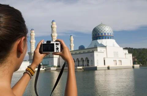 Malaysia, Borneo, Young woman taking photo of City Mosque in Kota Kinabalu Stock Photos
